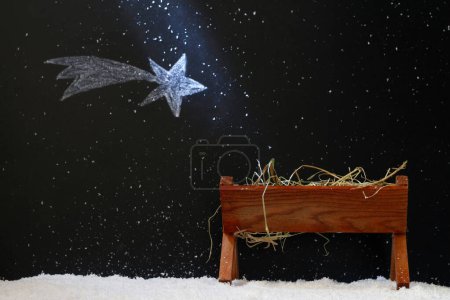 Téléchargez les photos : Manger et star de Bethléem lors d'une nuit enneigée, concept abstrait de crèche de Noël - en image libre de droit