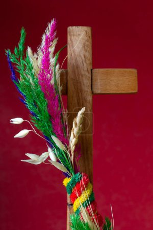 Photo for Traditional colorful palm and wooden cross on red background. Palm Sunday concept - Royalty Free Image
