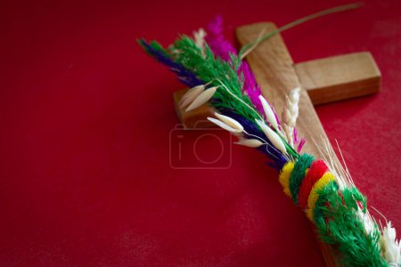 Photo for Traditional colorful palm and wooden cross on red background. Palm Sunday concept - Royalty Free Image