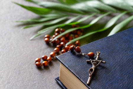 Photo for Bible with rosary and palm branch. Palm Sunday religious concept - Royalty Free Image