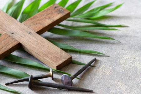 Photo for Wooden cross and old nails on palm branch. Palm Sunday religious concept - Royalty Free Image