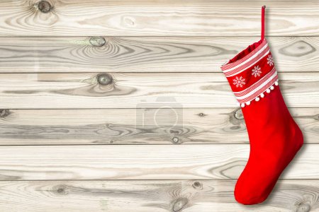 Photo for Red Christmas stocking on wooden background. Natural wood template - Royalty Free Image