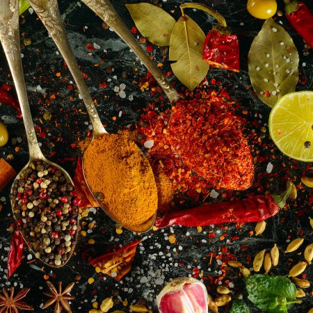 Photo for Many different spices and aromatic herbs on a dark table. View from above. - Royalty Free Image
