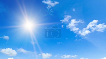 Photo for Light clouds and bright sun in the blue sky. - Royalty Free Image