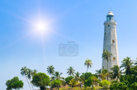 Beautiful white lighthouse Dondra Head, the southernmost cape of Sri Lanka - seen from the beach. The lighthouse is also a highest (161 feet) not only on the island but also in the whole Asia