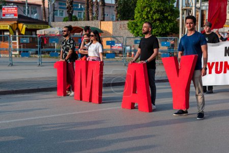 Foto de Los activistas están llevando cartas '1 DE MAYO' el 1 de mayo en la ciudad de Adana, país de Turquía.05.01.2024 - Imagen libre de derechos