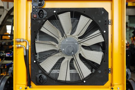 Photo for Close-up of part of huge industrial or construction machine with electric fan necessary dor cooling its engine during work - Royalty Free Image