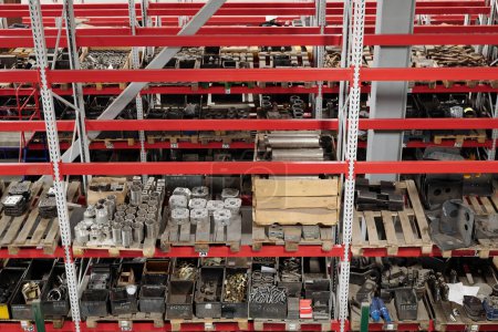 Téléchargez les photos : Part of spacious distribution warehouse of industrial plant with shelves full of spare parts for machines and repairing work - en image libre de droit