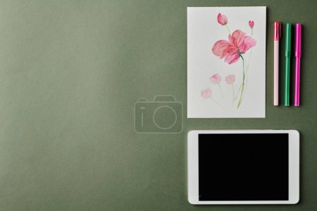 Photo for Flatlay of tablet, watercolor drawing of pink flower and three highlighters over workplace of modern designer with copyspace for your text - Royalty Free Image