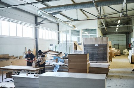 Photo for Image of big warehouse of furniture production with workers working in team - Royalty Free Image