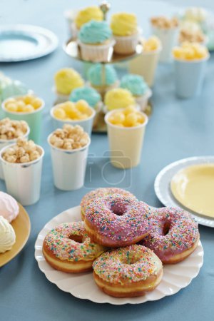 Photo for High angle view of candy bar with glazed baked donuts, cakes, sweets on table preparing for party - Royalty Free Image