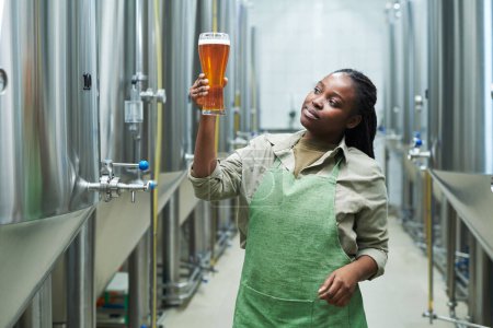 Photo for Microbrewery worker checking quality of produced beer - Royalty Free Image