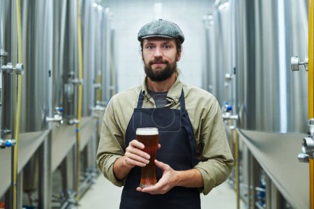Téléchargez les photos : Portrait de gérant de brasserie tenant un grand verre de bière - en image libre de droit