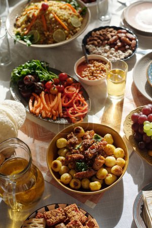 Vertical no people high angle view shot of delicious homemade dishes on abundant festive table on Uraza Bayram