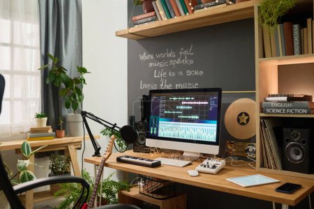 Téléchargez les photos : Workplace of creative musician composing music and writing lyrics with help of audio software, microphone and musical instruments - en image libre de droit