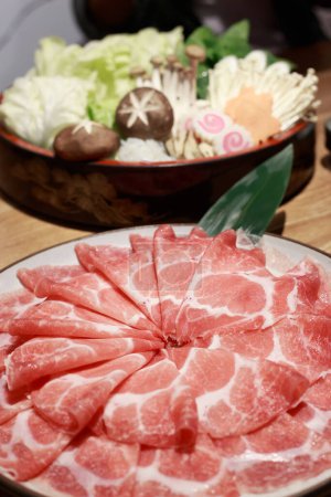 Experience the culinary allure of mouthwatering cuisine. Indulge in the visual feast of delicious sliced pork, shabu, and hot pot delights. Let your taste buds embark on a flavorful journey.