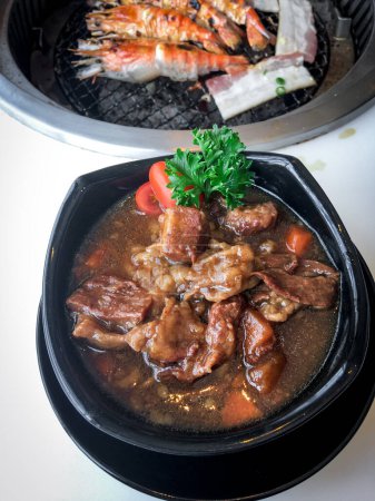 Indulge in the savory delight of Japanese-style braised beef. Captivating top-view photography showcasing exquisite cuisine in a stylish restaurant.