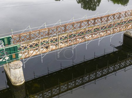 Photo for Scaffolding used for maintenance or restoration work on a small bridge over a large river the Cher - Royalty Free Image