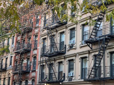 Photo for Old colorful buildings with fire ladder and trees on New-york manhattan, Upper East Side, buildings front house - Royalty Free Image