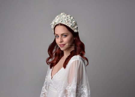 Photo for Close up portrait of beautiful red haired model wearing elegant pearl wedding headdress on a studio background. - Royalty Free Image