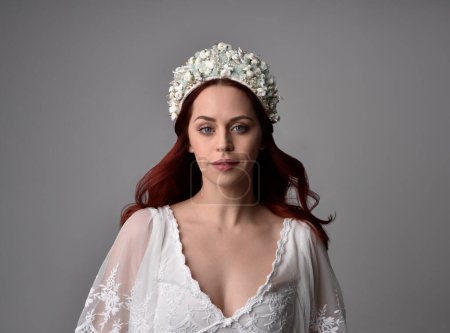 Photo for Close up portrait of beautiful red haired model wearing elegant pearl wedding headdress on a studio background. - Royalty Free Image