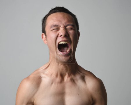 Photo for Close up portrait of asian male model, expressive and  exaggerated  facial expressions and silly faces. Isolated on a white studio background - Royalty Free Image