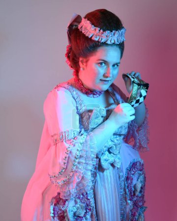  portrait of female model wearing an opulent pink gown,  costume of a historical French baroque nobility, style of Marie Antoinette. Isolated on  studio background cinematic  colourful lighting
