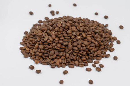 Photo for Spilled roasted coffee beans, place for Copy space, a bunch of coffee beans on a white background. - Royalty Free Image