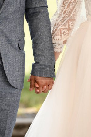 Photo for A pair of hands of a man and a woman keep each other, detailed and large, Bride couple - Royalty Free Image
