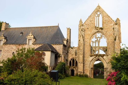 The main facade of Beauport Abbey, a roofless gothic building located in Paimpol, Cotes d'Armor, Brittany, France. August 2023, sunset view.