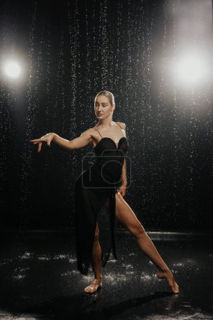 Photo for Dancer in a black dress in the studio on the aquazone. High quality photo - Royalty Free Image