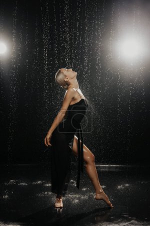 Photo for Dancer in a black dress in the studio on the aquazone. High quality photo - Royalty Free Image
