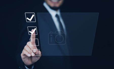 Photo for Businessman touch on digital screen check correct sign mark in checkbox for quality document control checklist for business approve. - Royalty Free Image