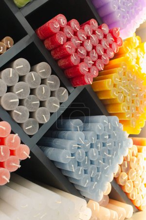 Photo for Colourful candle sticks on shelf. Candle shop. Household equipment. Different wax candles in store. Aroma candles. Romance accessories. Stack of variety of candles. - Royalty Free Image