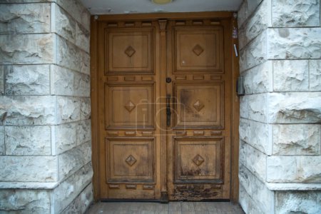 old damaged wooden door, strong, with carvings, entrance to a residential building
