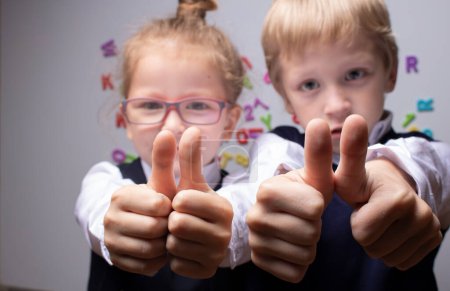 Photo for Schoolers in form showing thumb-up on math background - Royalty Free Image