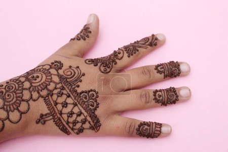 Image of hand painted on henna mehendi tattoo. Indian Mehendi celebration. Henna application and rituals. Indian bride and bridesmaid showing henna art