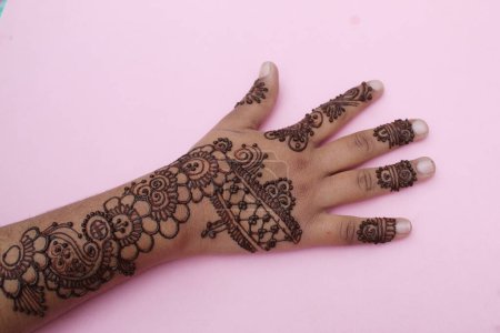 Image of hand painted on henna mehendi tattoo. Indian Mehendi celebration. Henna application and rituals. Indian bride and bridesmaid showing henna art