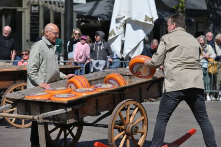 Photo for Alkmaar, Holland - April 22, 2022: Unidentified people at demonstration of how this merchants market operated in times gone at traditional Cheese Market in Alkmaar, Holland - Royalty Free Image