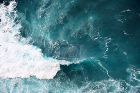 Turquoise ocean water background. View from above to the waves of the ocean