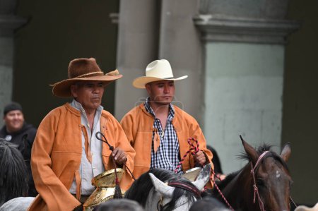 Photo for Oaxaca, Mexico - July 09, 2023: Mexican Cowboys riding beautiful horses at the parade in city street, Oaxaca, Mexico - Royalty Free Image