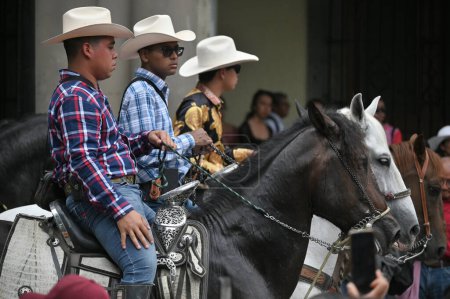 Photo for Oaxaca, Mexico - July 09, 2023: Mexican Cowboys riding beautiful horses at the parade in city street, Oaxaca, Mexico - Royalty Free Image