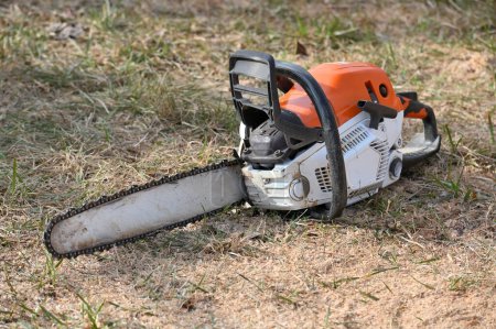 Photo for Close up professional chainsaw. Blade of a chainsaw in the garden. - Royalty Free Image