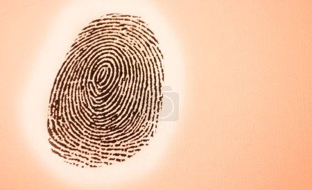 Photo for Black fingerprint with orange background - Royalty Free Image