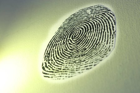 Photo for Black fingerprint on a yellowish background - Royalty Free Image