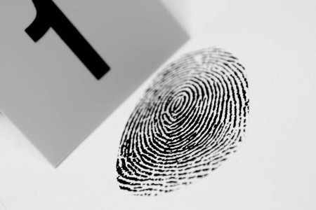 Photo for Black fingerprint with a crime scene marker - Royalty Free Image