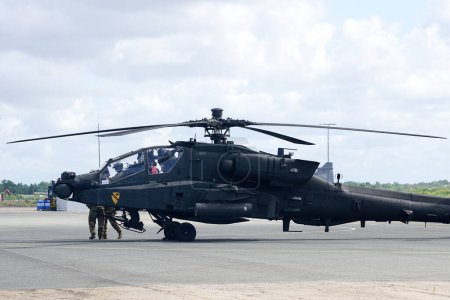 Photo for Liepaja, Latvia - August 07, 2022: AH-64D Apache attack helicopter from United States army with crew after landing at the airport runway - Royalty Free Image