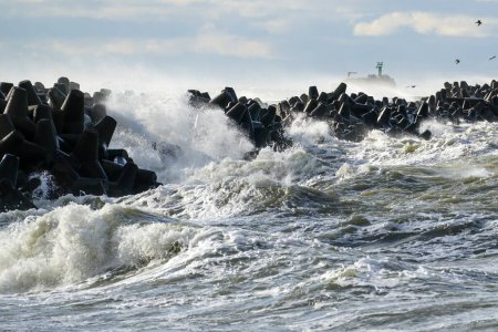 Photo for Big waves breaking over harbor breakwall in the Baltic Sea - Royalty Free Image