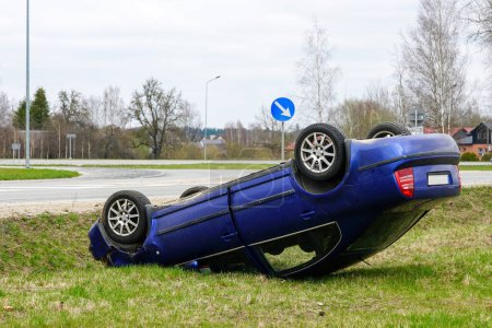 Photo for Car accident scene, a passenger car left the road and overturned with its wheels up, overturned car - Royalty Free Image