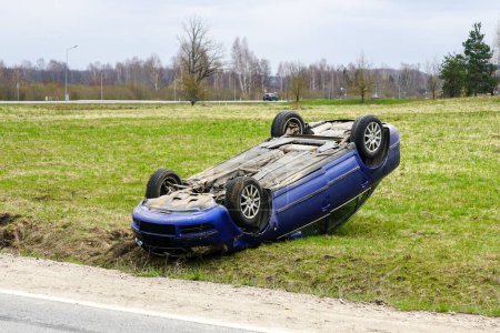 Photo for Car accident scene, a passenger car left the road and overturned with its wheels up, overturned car - Royalty Free Image